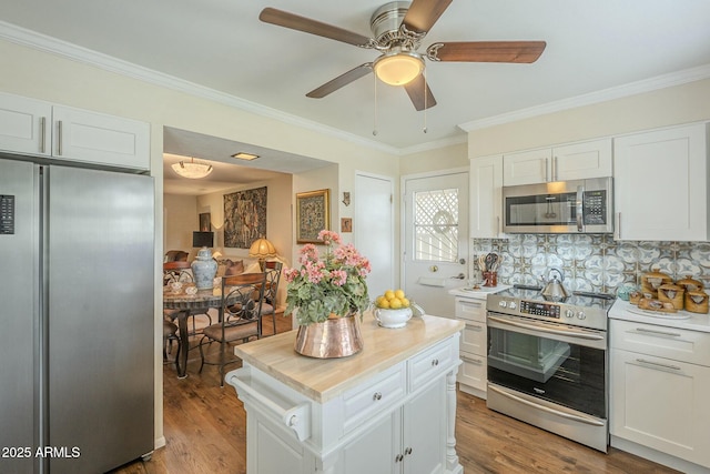 kitchen featuring white cabinetry, appliances with stainless steel finishes, wood finished floors, and light countertops