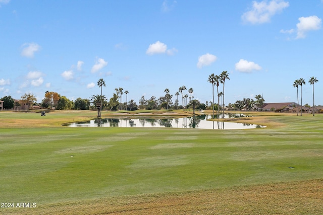 surrounding community with a lawn and a water view