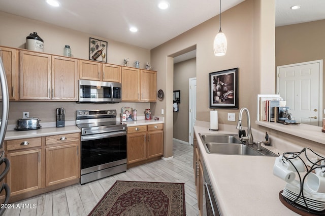 kitchen with sink, stainless steel appliances, light hardwood / wood-style flooring, decorative light fixtures, and light brown cabinetry