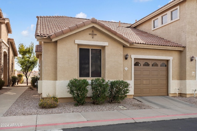 mediterranean / spanish-style house with a garage