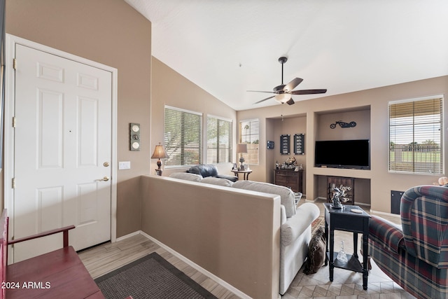 living room featuring ceiling fan, light hardwood / wood-style floors, and lofted ceiling