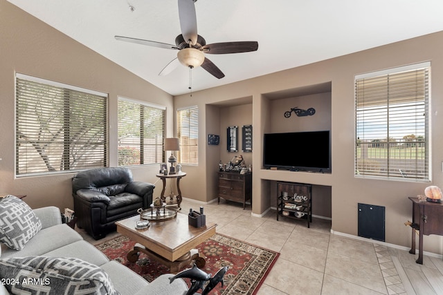 living room featuring ceiling fan, light tile patterned floors, and vaulted ceiling