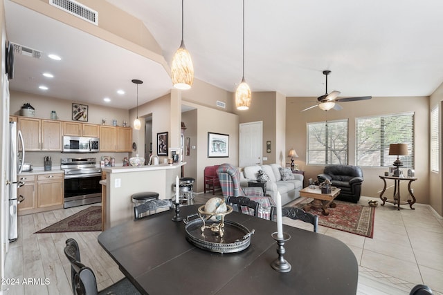 dining room featuring light hardwood / wood-style flooring, ceiling fan, and lofted ceiling