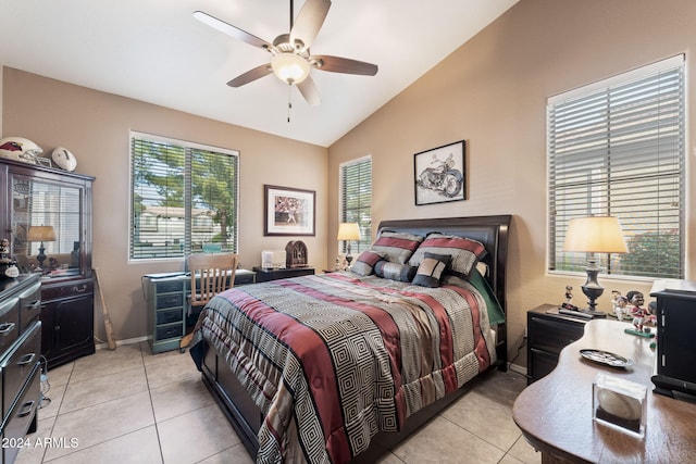 bedroom featuring ceiling fan, light tile patterned floors, and vaulted ceiling