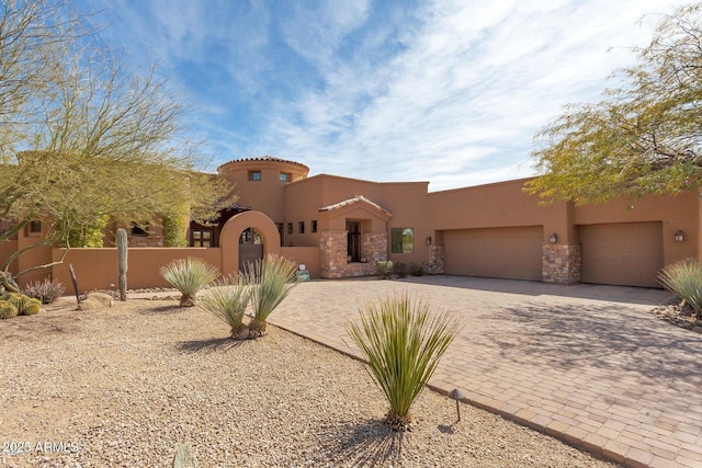 35195 N 98th St Unit 85, Scottsdale, AZ 85262 - view of front facade featuring stucco siding, decorative driveway, and a garage
