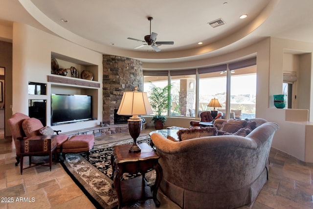 35195 N 98th St Unit 85, Scottsdale, AZ 85262 - living room with stone tile floors, ceiling fan, a raised ceiling, and recessed lighting