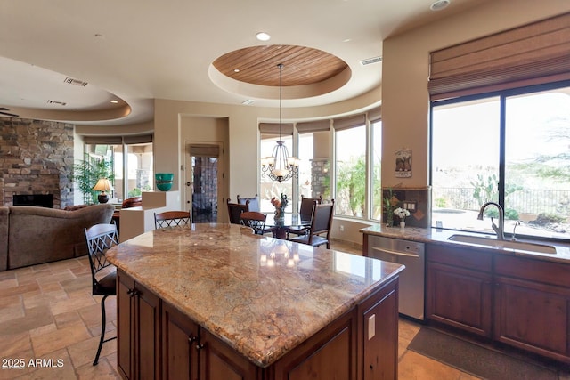 35195 N 98th St Unit 85, Scottsdale, AZ 85262 - kitchen featuring dishwasher, a raised ceiling, a sink, a fireplace, and a chandelier