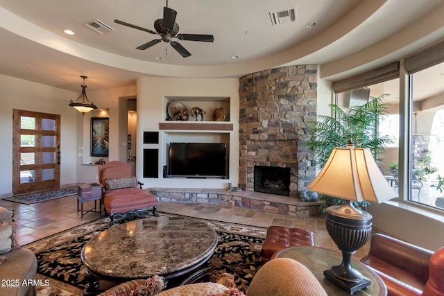 35195 N 98th St Unit 85, Scottsdale, AZ 85262 - living area with a ceiling fan, built in features, a stone fireplace, and recessed lighting