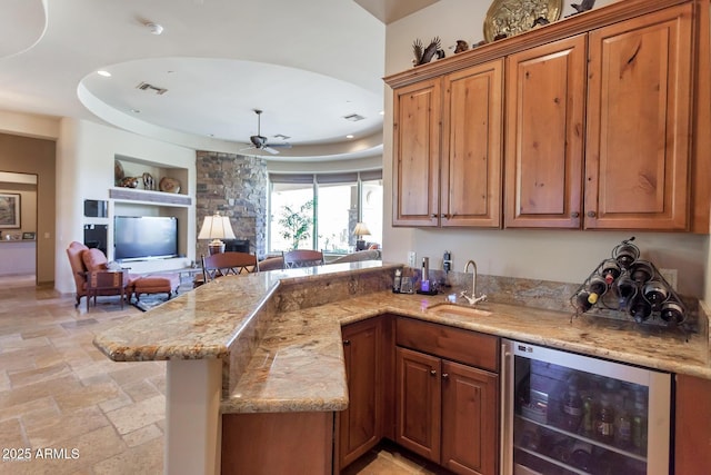 35195 N 98th St Unit 85, Scottsdale, AZ 85262 - kitchen with beverage cooler, a sink, built in shelves, light stone countertops, and stone tile flooring