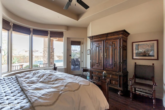35195 N 98th St Unit 85, Scottsdale, AZ 85262 - bedroom featuring dark wood-type flooring, access to outside, and a tray ceiling