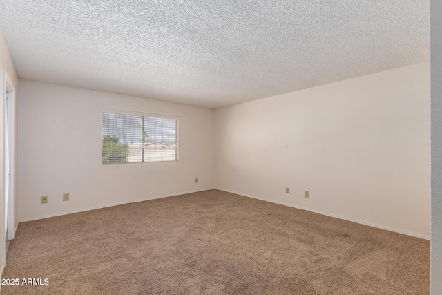 unfurnished room featuring light carpet and a textured ceiling