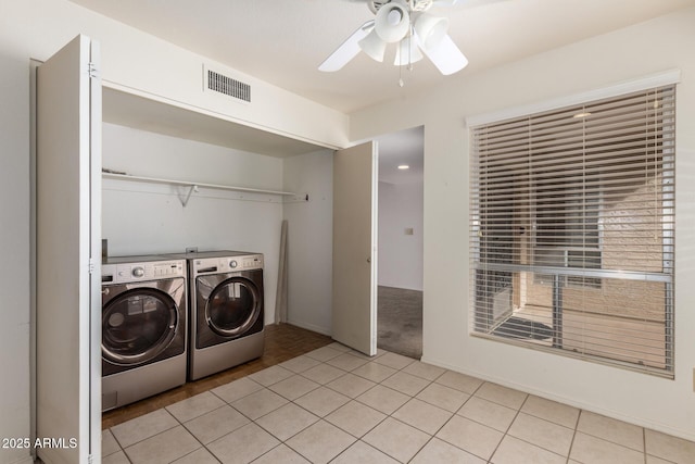 laundry area featuring visible vents, laundry area, separate washer and dryer, ceiling fan, and tile patterned floors