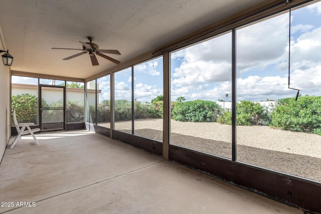 unfurnished sunroom featuring ceiling fan