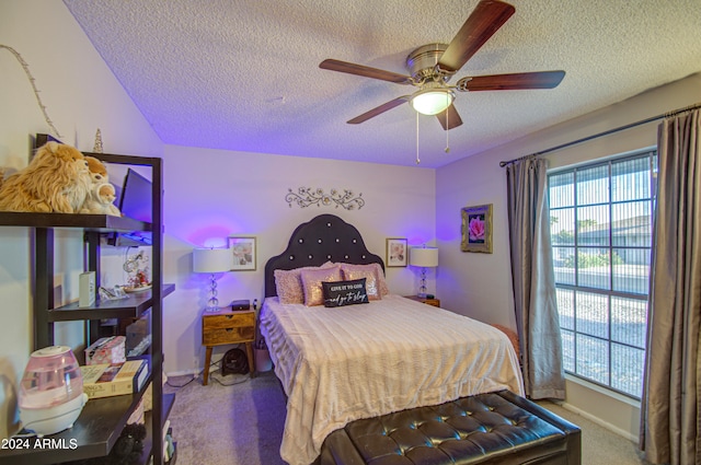 carpeted bedroom featuring a textured ceiling and ceiling fan