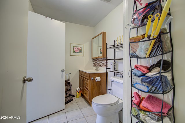 bathroom with vanity, toilet, and tile patterned floors