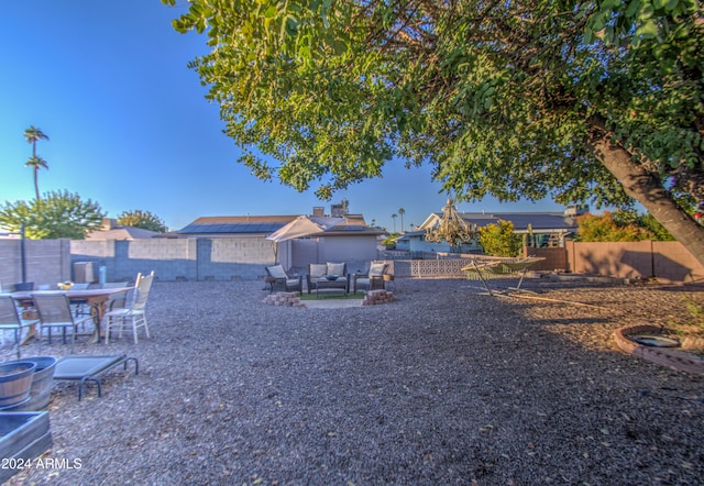 view of yard with an outdoor living space with a fire pit and a patio