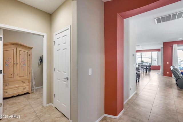 hallway featuring light tile patterned floors