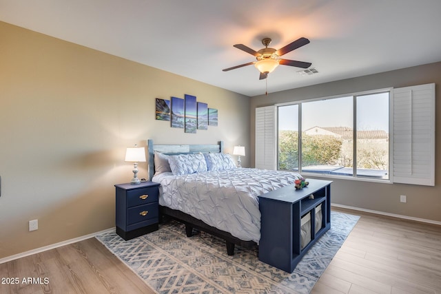 bedroom with wood-type flooring and ceiling fan