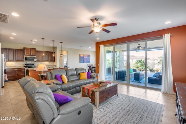 tiled living room with ceiling fan