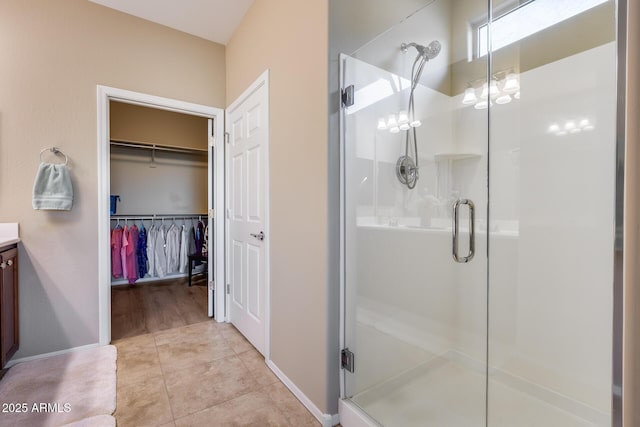 bathroom featuring vanity, an enclosed shower, and tile patterned flooring