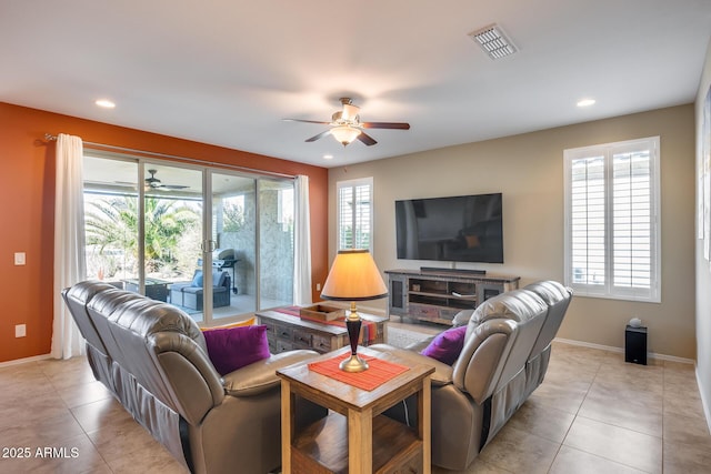 tiled living room featuring plenty of natural light and ceiling fan