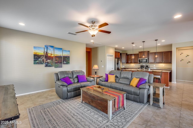 living room featuring light tile patterned flooring and ceiling fan