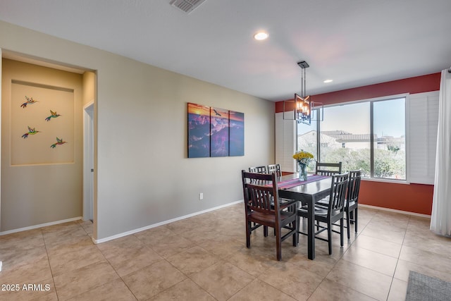 dining room featuring a chandelier and light tile patterned floors