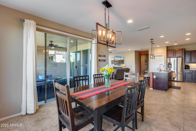 dining area with sink, ceiling fan, and light tile patterned flooring