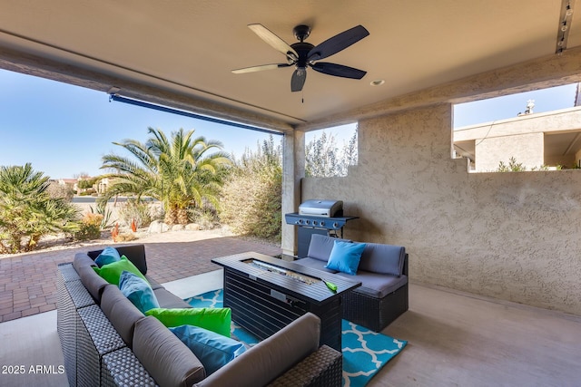 view of patio featuring grilling area, an outdoor living space with a fire pit, and ceiling fan