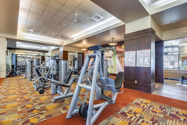 exercise room with carpet floors and a drop ceiling