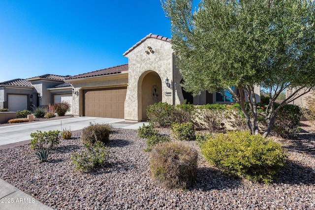 mediterranean / spanish home featuring a garage