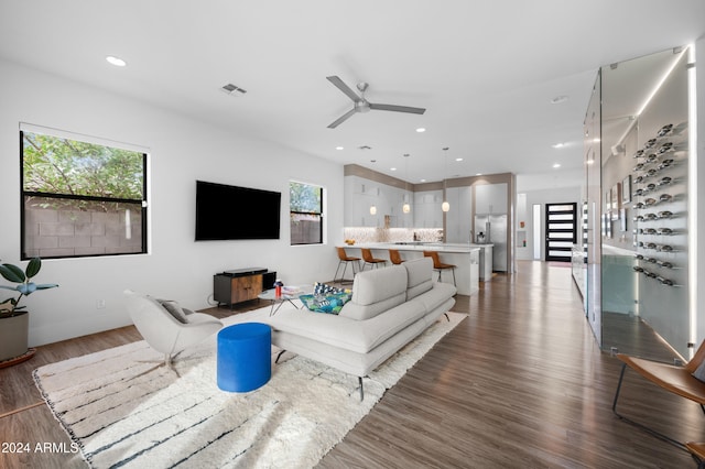 living room with hardwood / wood-style floors and ceiling fan