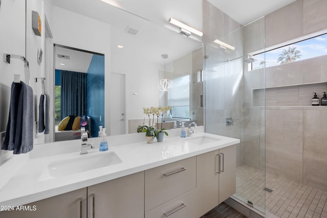 bathroom with vanity, a healthy amount of sunlight, and an enclosed shower