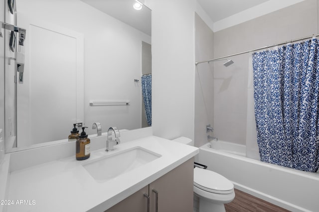 full bathroom with shower / bath combination with curtain, vanity, hardwood / wood-style flooring, and toilet