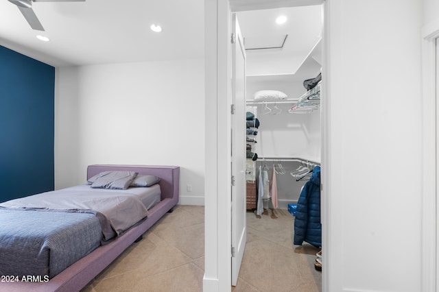 tiled bedroom featuring a closet and ceiling fan