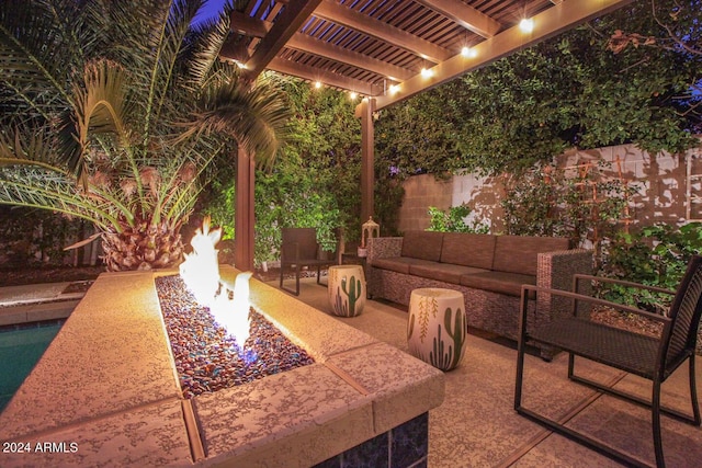 patio at twilight featuring a pergola and an outdoor living space with a fire pit