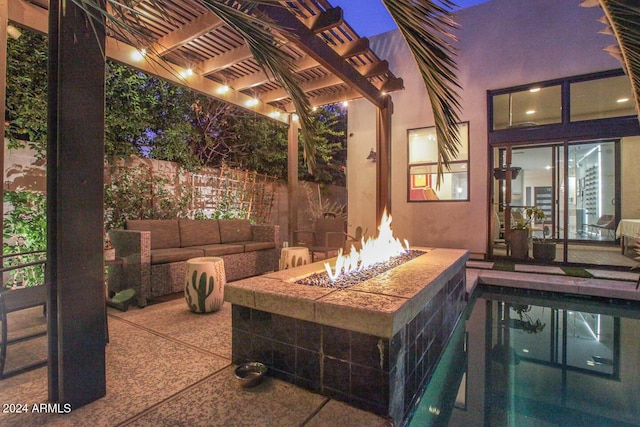 view of patio / terrace with a pergola and an outdoor fire pit