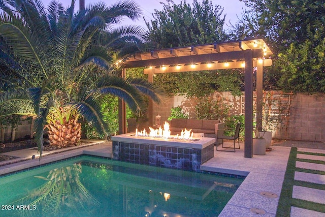 view of pool featuring an outdoor fire pit and a patio