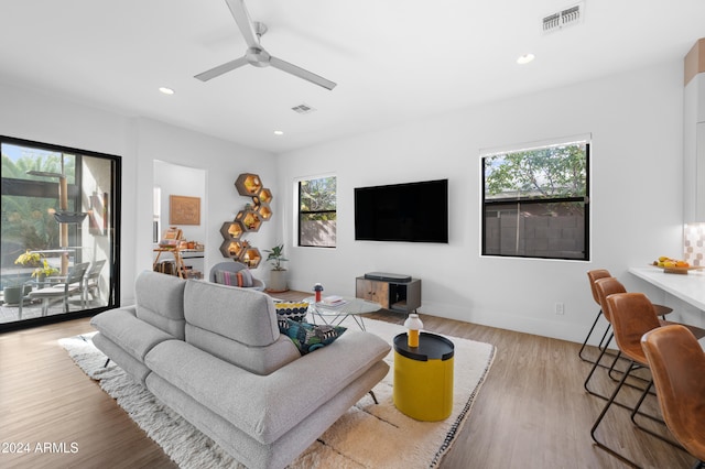 living room featuring ceiling fan and light wood-type flooring