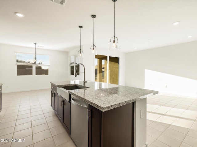 kitchen featuring light tile patterned flooring, stainless steel dishwasher, decorative light fixtures, and sink