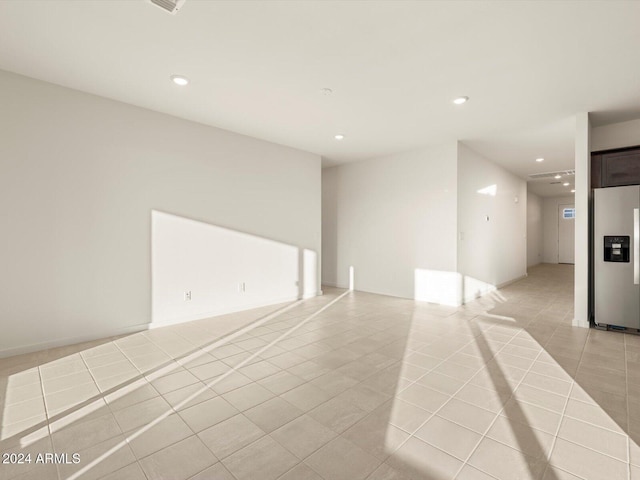 spare room featuring light tile patterned floors