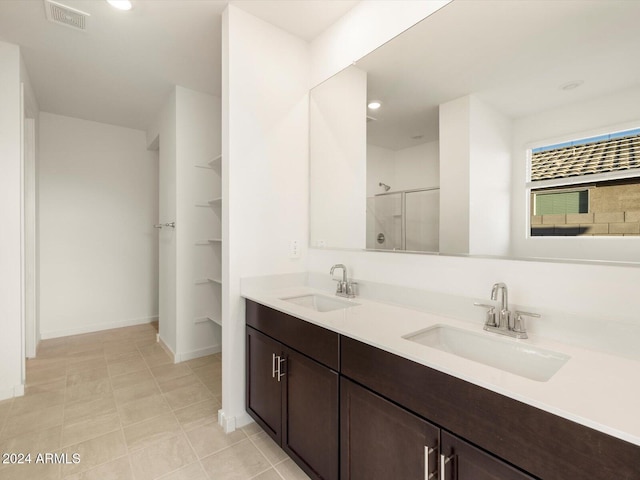 bathroom featuring an enclosed shower and vanity