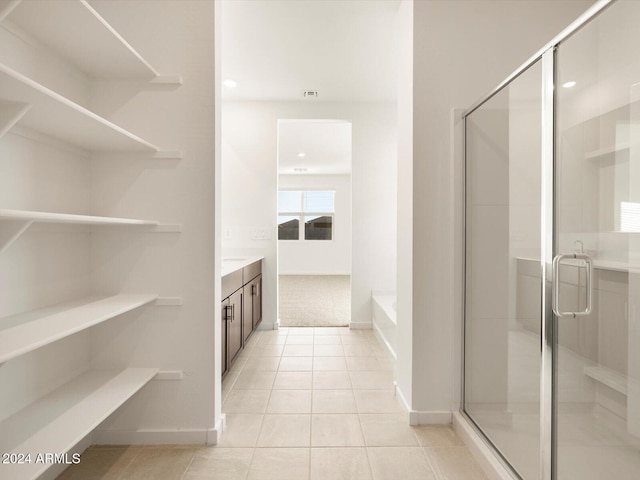 bathroom with vanity, tile patterned flooring, and separate shower and tub