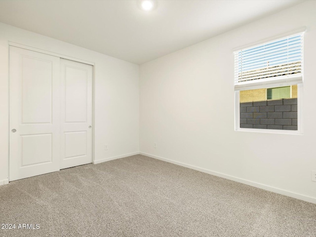 unfurnished bedroom with a closet and carpet flooring