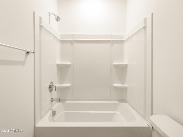 bathroom featuring bathing tub / shower combination and toilet