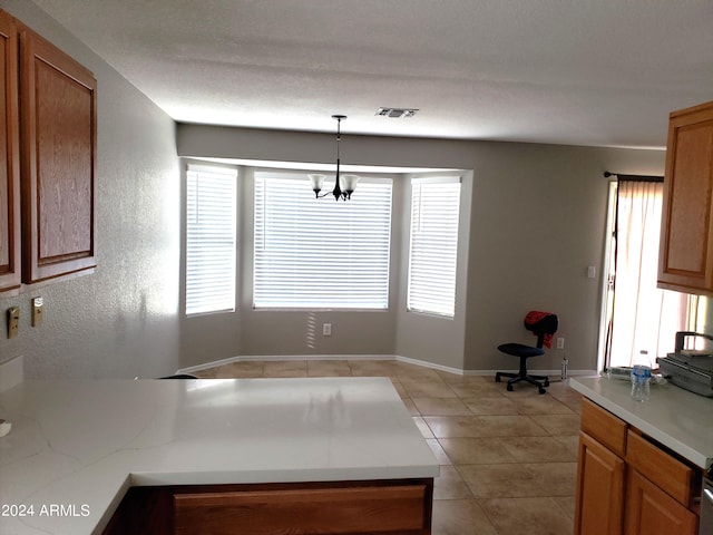 unfurnished dining area featuring a notable chandelier, light tile patterned floors, and plenty of natural light