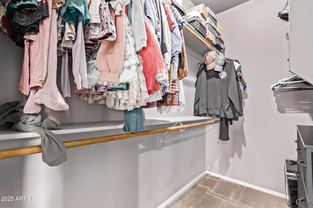 walk in closet featuring carpet