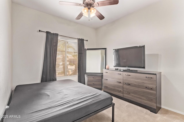 bedroom with baseboards, light carpet, and a ceiling fan