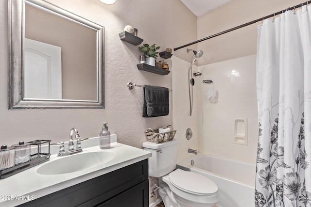 bathroom featuring vanity, a textured wall, shower / bath combination with curtain, and toilet