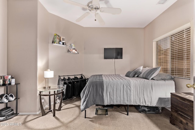 carpeted bedroom featuring baseboards and ceiling fan